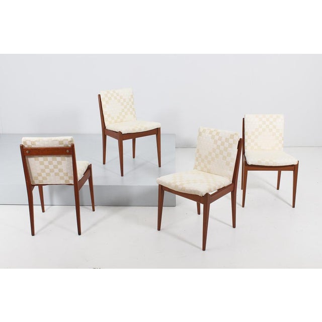 Wonderful and elegant set of four chairs with a harmonious and geometric design with shaped and wood structure and padding...