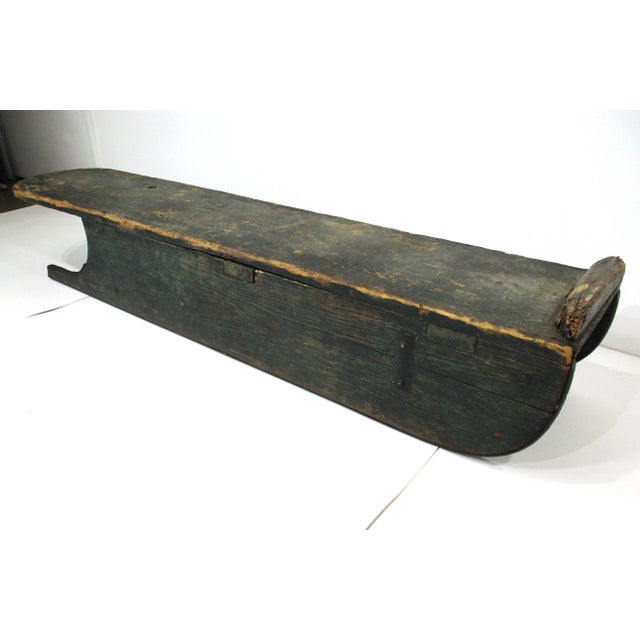A great painted green wood antique snow, ice toboggan sled with metal runners all with wonderful patina and perfect wear...
