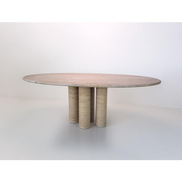 Italian travertine dining table based on the iconic **Il Colonnato** design by Mario Bellini, manufactured around 1980....