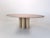 Italian travertine dining table based on the iconic **Il Colonnato** design by Mario Bellini, manufactured around 1980....