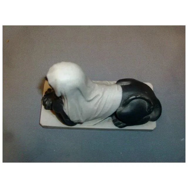 A very interesting Egyptian Revival bisque model of a recumbent sphinx resting on an octagonal plinth. Draped in fabric...