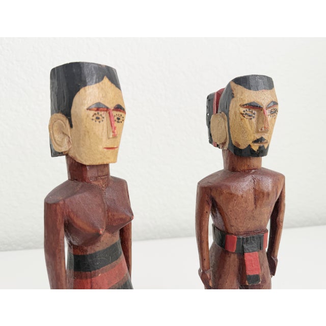 Pair of Mid 20th century carved wooden figures from Kutu Island, Micronesia. Male and Female figures each depicted with...