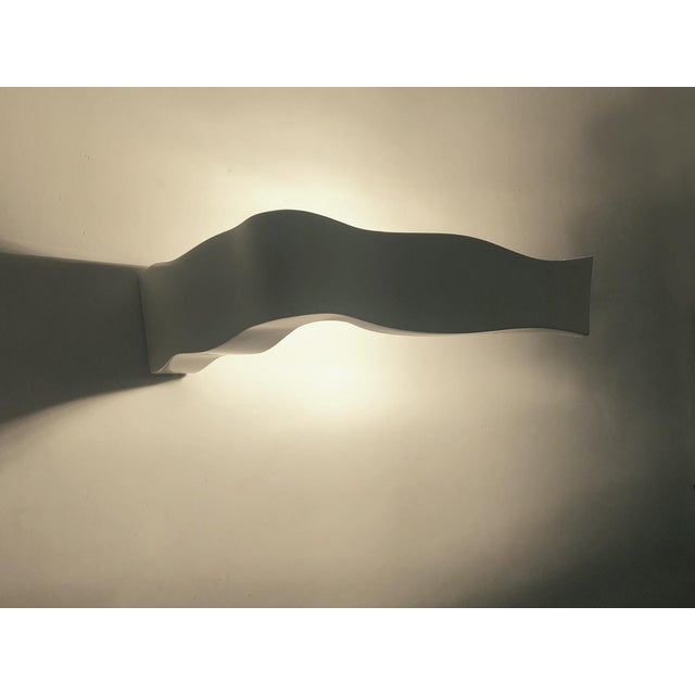 Pair of Italian Fontana Arte Yves wall lights, white, 2008 These wall lights feature a sophisticated design that diffuses...