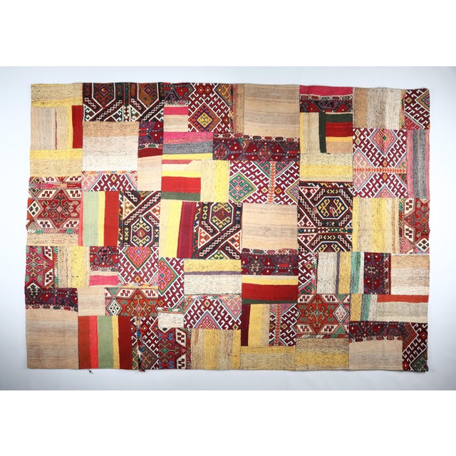 This striking patchwork kilim is a one of a kind composition crafted from handwoven vintage fragments of tribal Turkish...