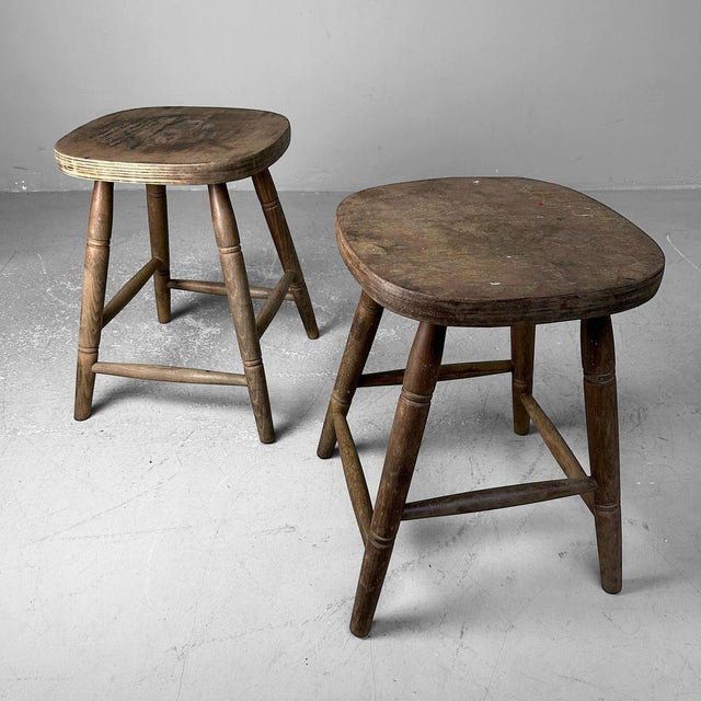 Set of two classic English wooden stools from the 1920s. Dimensions: height 46 cm, width 36 cm, depth 35 cm. This set is a...