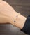 This exquisite bangle bracelet captivates with its modern allure. Adorned with 7 natural striking blue oval sapphires,...