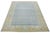 This hand-knotted wool rug features a light blue background with yellow and beige accents in a framed design. This rug...