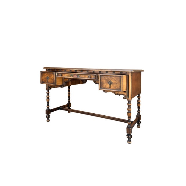 This charming desk features a wide and relatively shallow beveled top, three shallow drawers underneath with round,...