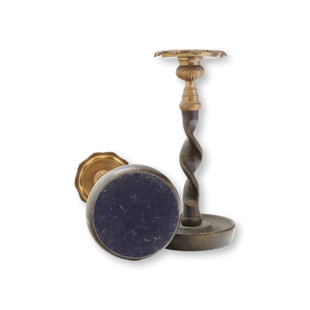 Pair of late 20th century heavy metal and brass candle holders with twisted stems and stepped circular bases. The recessed...