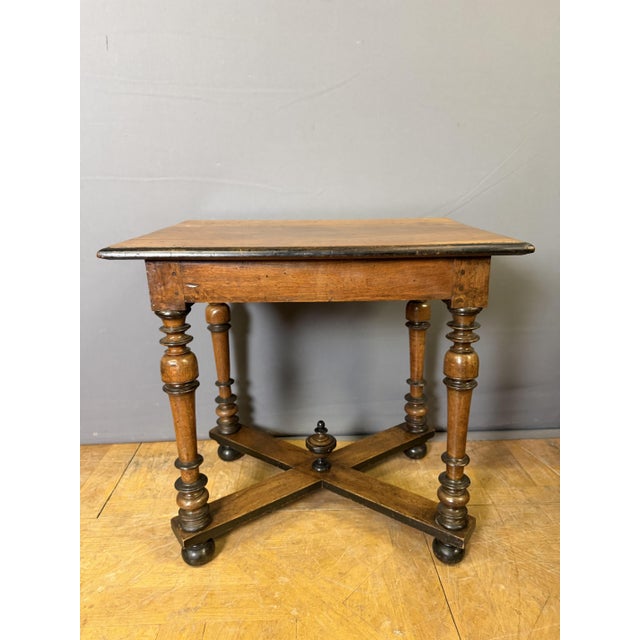 A writing table with one drawer, partly from the Louis XIII period, resting on four turned legs joined by X-shaped...