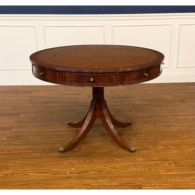 This is a Classic Traditional Round Mahogany Drum Table by Leighton Hall. It features a leather top, four dovetailed...