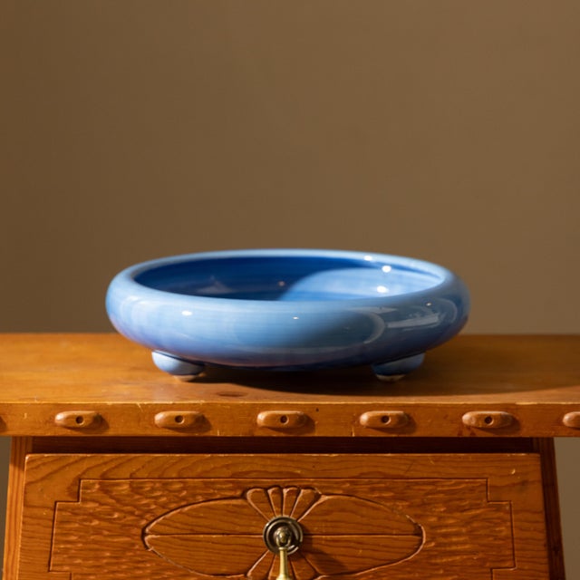 Dimensions: 12" W x 12" D x 3.25" H Description: A substantial 1920s Japanese Awaji art pottery low bowl featuring a...