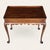 A refined Georgian-style mahogany side table by Kittinger Company, featuring a raised gallery (tray) top, scalloped apron,...