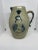 Antique salt-glazed pitcher from the 1800s. There is a bulldog on each side along with a male face. There are some chips...
