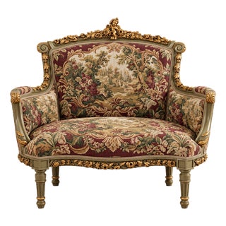 French Louis XVI Style Armchair – Floral Tapestry Upholstery, Gold Leaf Frame & Cherub Crest For Sale