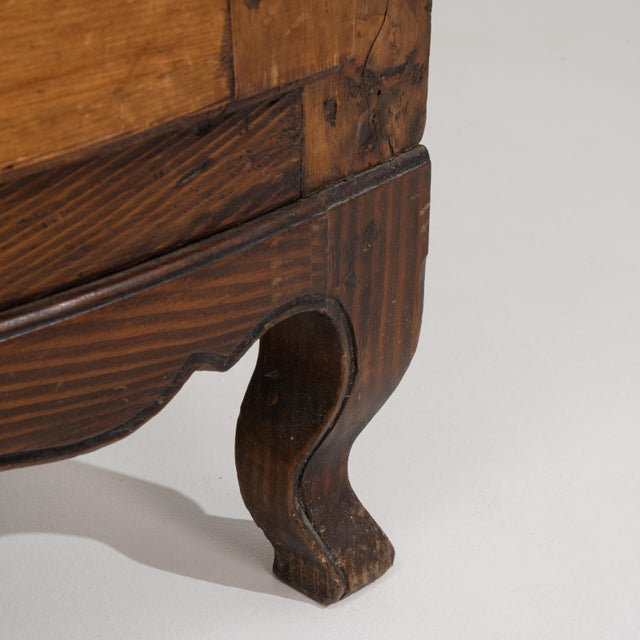A Louis XV corner cabinet designed to fit into angled spaces. The front features a curved profile with paneled...