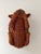 Woven rattan figure shaped like a reclining rabbit with a hollow basket section on its back.