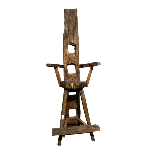 Sculptural walnut and olive wood chair with curved armrest. Hand-crafted work made with the remains of old farm implements...