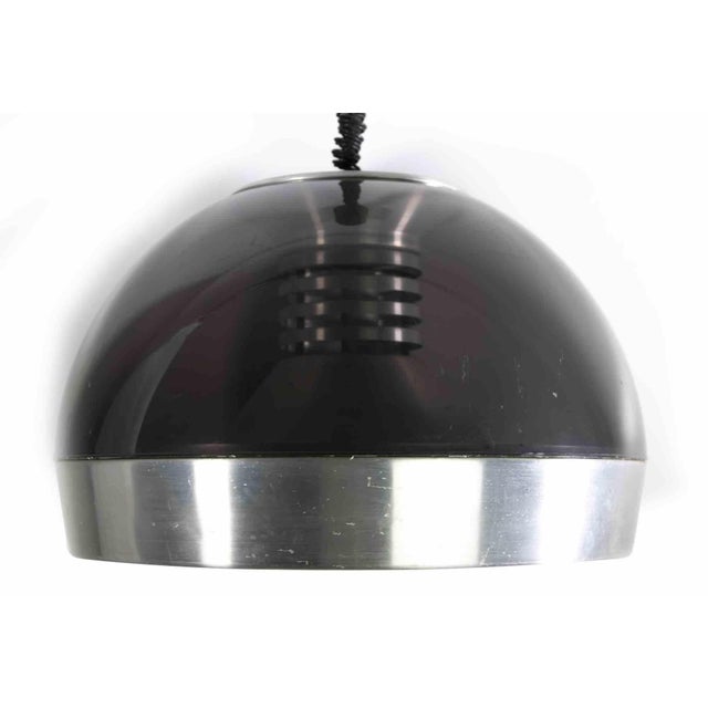 Space Age Chandelier is an original design lamp realized in the 1970s. This vintage lamp is realized in fumé acrylic glass...