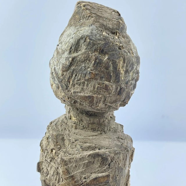 This Bakongo wooden figure from the Democratic Republic of Congo is a striking example of traditional power sculpture,...