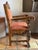 An imposing Spanish Colonial Revival armchair crafted from dense hardwood with a rich, honey-brown patina. Borrowing from...