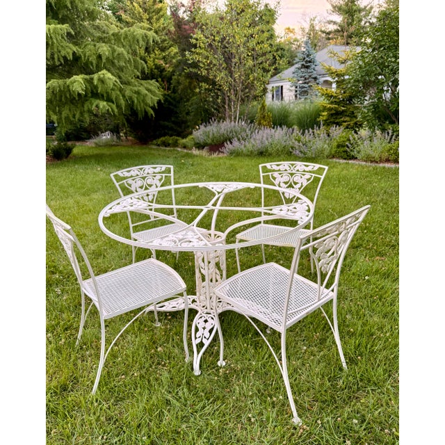 A romantic mid-century garden dining set in Meadowcraft’s “Meadow Rose” pattern — climbing roses, trailing leaves, and...