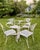A romantic mid-century garden dining set in Meadowcraft’s “Meadow Rose” pattern — climbing roses, trailing leaves, and...