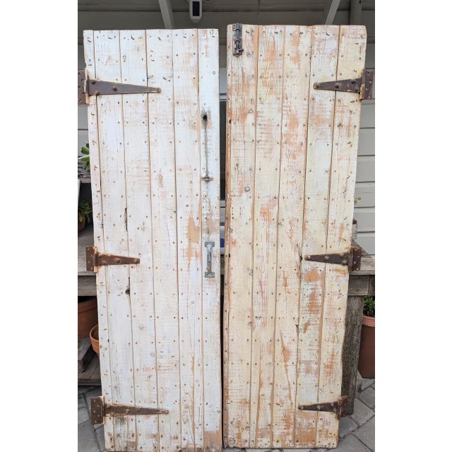 Stunning pair of authentic vintage solid wood barn doors. Both sides of the doors are different and incredibly gorgeous.