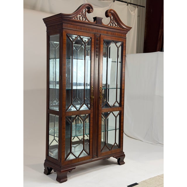 This is an elegant Georgian style mahogany display cabinet by Henkel Harris, finely crafted in the United States with a...