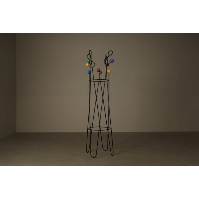 Decorative contemporary freestanding coat and hat stand in the style of the playful mid-century designs associated with...