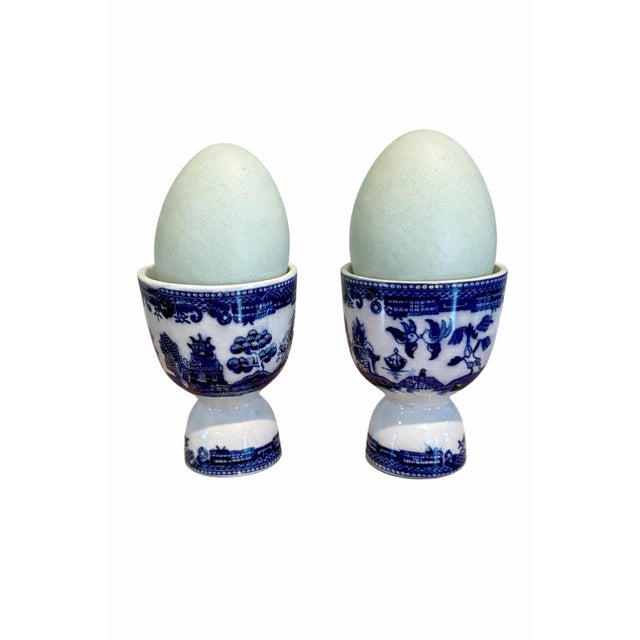 Vintage pair of double egg cups featuring classic Blue Willow transferware chinoiserie landscape scenes with pagodas,...