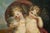 An antique oil painting on wood depicting a pair of winged cherubs in a landscape, dating from the late 18th century. The...