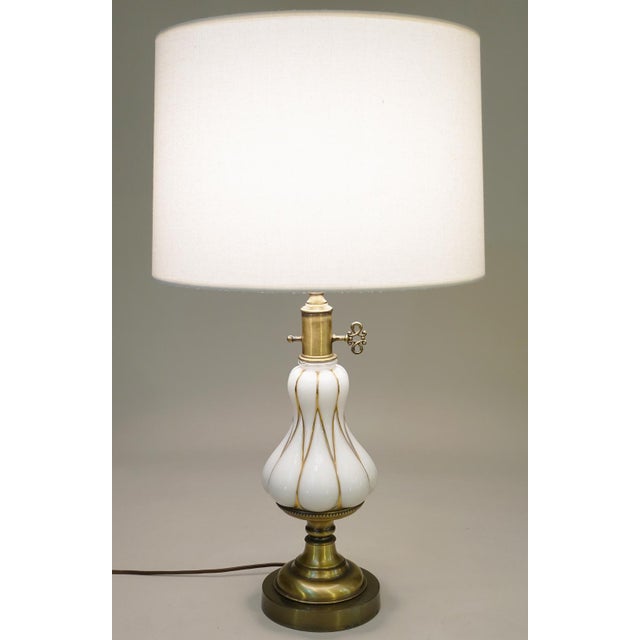 A sculpturally sensual White Opaline Art Glass and Brass table lamp designed and manufactured by Stiffel lighting circa...