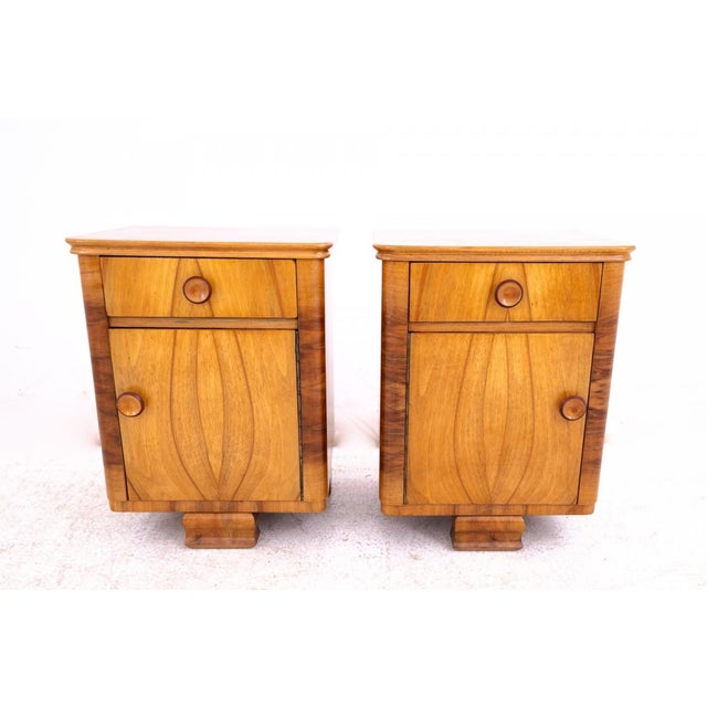 An elegant pair of nightstands from Poland, dating to around 1940. Crafted from beautifully grained walnut, they captivate...