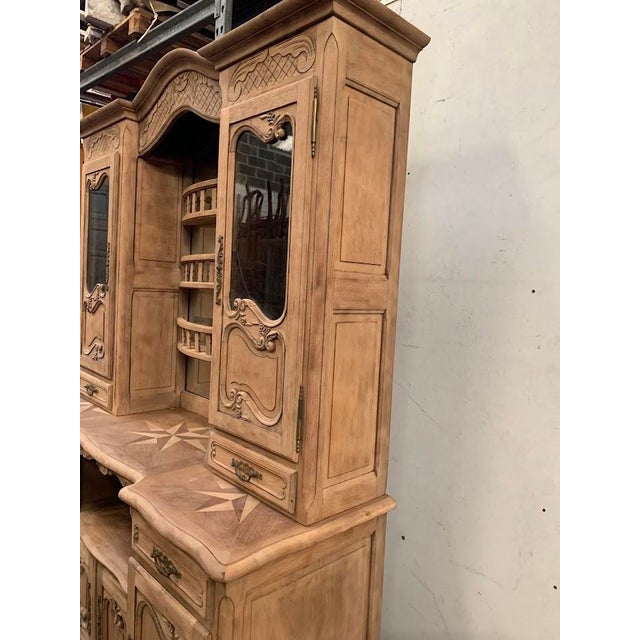 Two-part solid oak buffet Lower section with four doors and two drawers on the front Upper section with glass doors and a...
