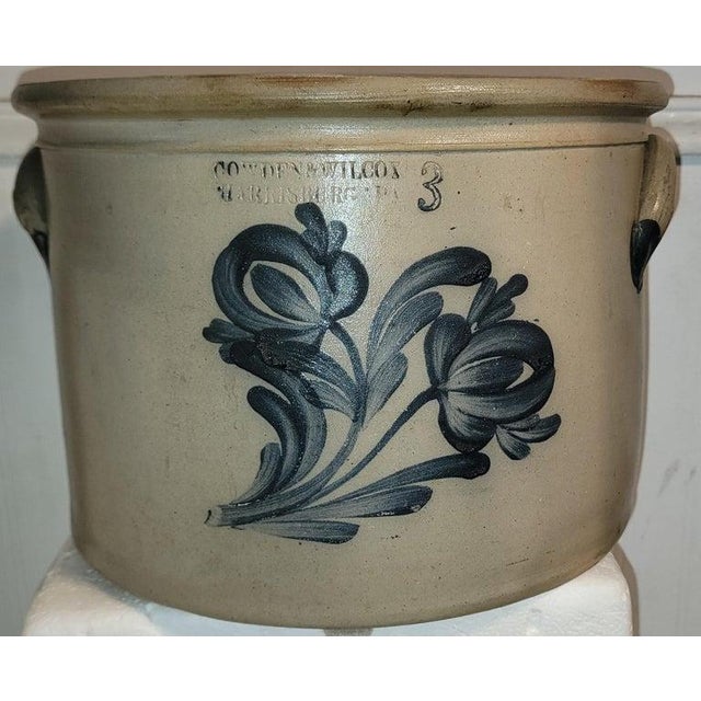 This fine decorated 19thc stone ware crock from Cowden & Wilcox in Harrisburg,Pennsylvania.This folky tulip hand painted &...