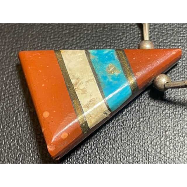 Pueblo Native American Santo Domingo triangular pendant necklace, 18.5 inches long. The pendant (30mm. x 25mm.) is...