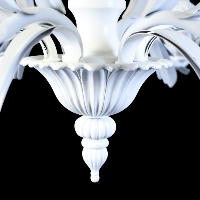 A white pineapple chandelier — the classic symbol of hospitality rendered as a sculptural ceiling fixture. The detailed...