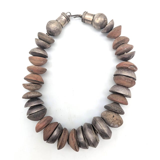 Offered is a chunky artisan-crafted choker statement necklace featuring large, barrel-shaped and round hammered silver...