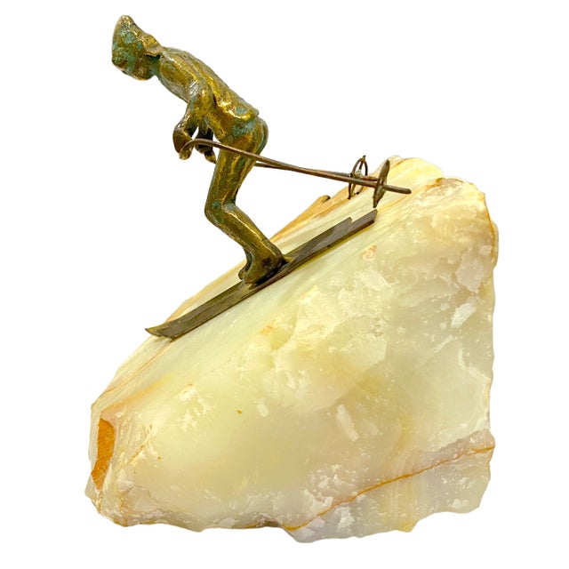 A beautiful Curtis Jere sculpture, capturing a vintage skier in mid-descent. Crafted in the company's signature mixed...