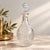 An elegant vintage glass decanter attributed to the Metropolitan Museum of Art's 1970s reproduction collection, inspired...