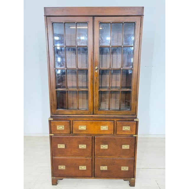 Perfectly suited to classic English colonial style, this beautiful, two-part campaign display cabinet is for sale. The...