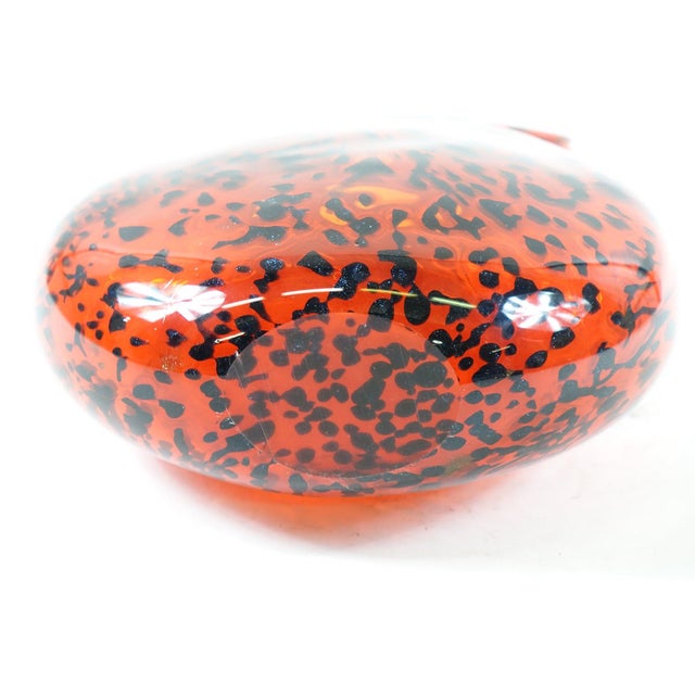 This is a Decorative Art Glass Vase, measuring 10ʺ × 5ʺ × 14ʺ, featuring a striking red color with intricate black and...