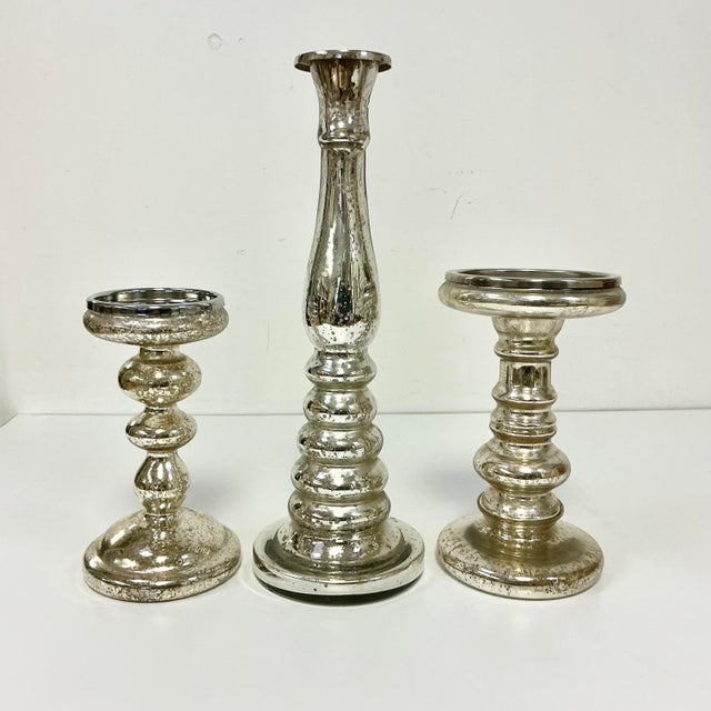 This set of three large Mercury Glass Candle Holders are attributed to West Elm. The set features three different shaped...