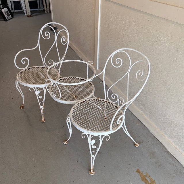 Beautiful shabby chic garden bench, metal with ivy floral details on legs. Also has umbrella stand built in, as well as...