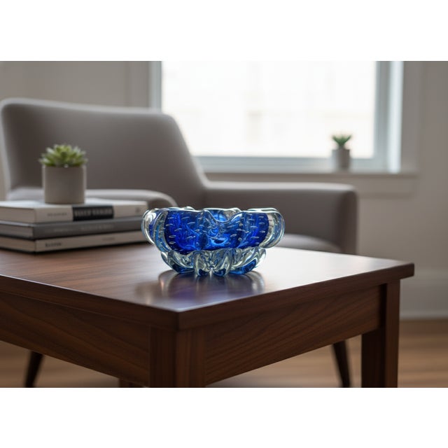 Murano glass ashtray with a submerged and bubbling effect, vintage from the 1970s. The bubbling effect, with its...