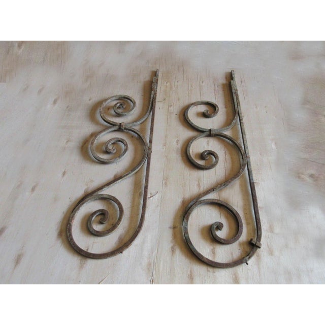 These iron brackets are wonderful pieces of architecture and are heavy, tight, and sturdy. The pieces do shown signs of...