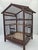 An original, large wooden birdcage from the early 20th century, handcrafted from wood and iron rods. This model features a...