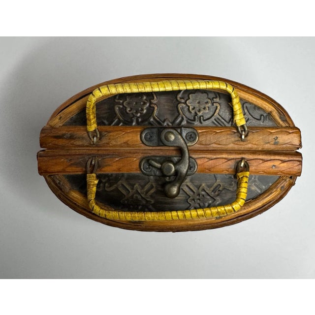 A soft trapezoid shape and rounded corners and base adorn this rattan wrapped double handled basket. A black painted strip...