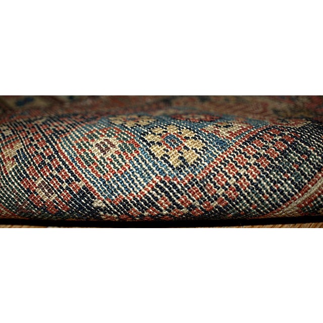 Experience the timeless elegance of this finely handcrafted antique Middle Eastern Farahan rug. Measuring 4.3' x 6.4'...